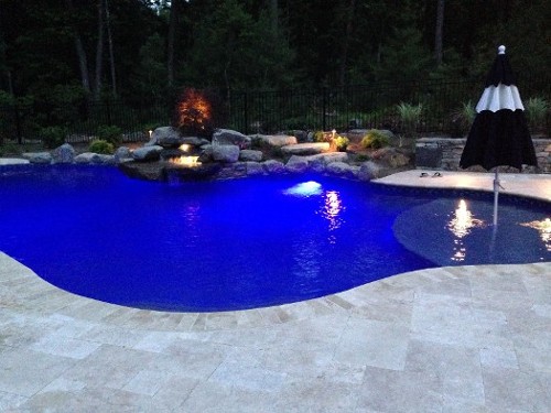 Pool with Wading Shelf, Night Lights, Waterfall and Travertine Coping by New View