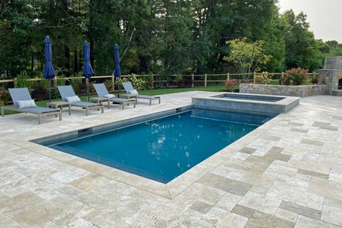 Travertine patio with pool and spa design by New View