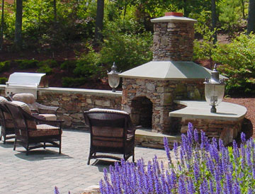 Fireplace with Raised Hearth, Angled Blue Stone Mantle, Walls with Light Posts and Patio by New View