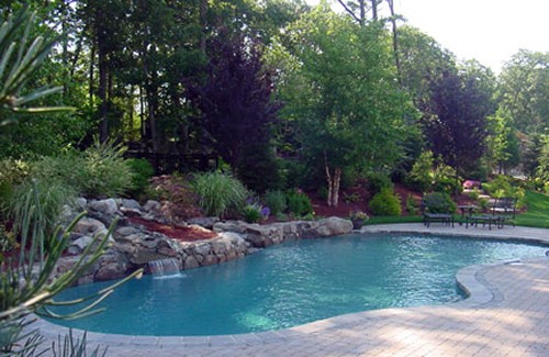 Pool with Elevated Travertine Deck and Steps, Stone Wall and Waterfall by New View