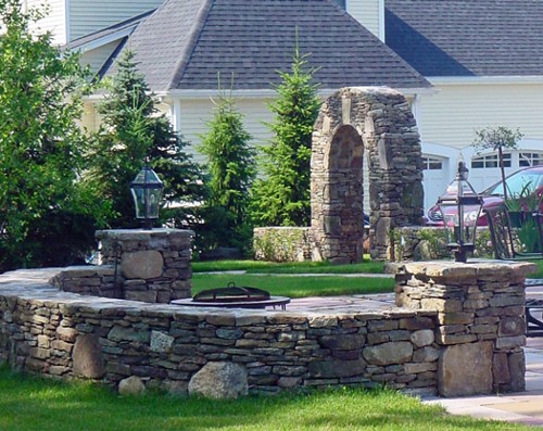 Stone Wall with Posts and Arched Garden Entrance by New View