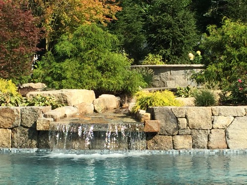 Hot Tub nestled in nature and overlooking the pool and waterfall_New View, Inc.