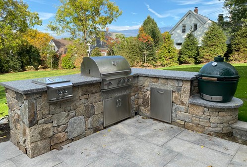 Stone Bar with Built in Grill,  Big Green Egg, Trash Center and Side Burner by New View