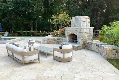 Stone Fireplace, wall and travertine patio by New View